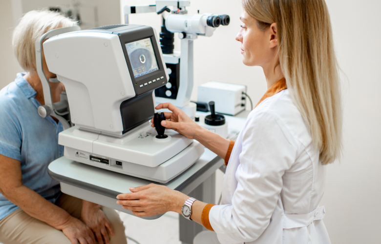 Ophthalmologist examining the eyes of an older patient using a digital microscope during a medical examination.